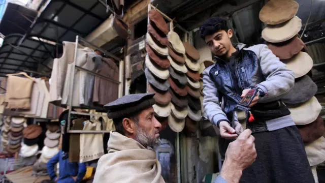 A man sells traditional Chitrali caps as winter season begins, in Peshawar, Pakistan, 09 January 2017.
