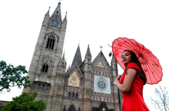 A member of the Chinese community in Mexico takes part in a fashion show at Esplanade of "Templo Expiatorio" in Guadalajara, Jalisco state, Mexico on February 16, 2018. Members of the Chinese community living in Mexico are preparing for the celebration of the Chinese New Year, the "Year of the Dog". / AFP PHOTO / ULISES RUIZULISES RUIZ/AFP/Getty Images