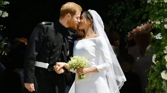 Prince Harry and Meghan Markle kiss on the steps of St George"s Chapel in Windsor Castle after their wedding. PRESS ASSOCIATION Photo. Picture date: Saturday May 19, 2018.