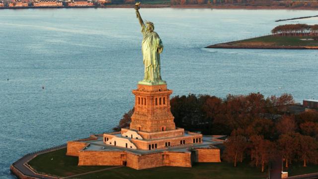 The sun lights the Statue of Liberty which is on the UNESCO World Heritage Cultural List in New York
