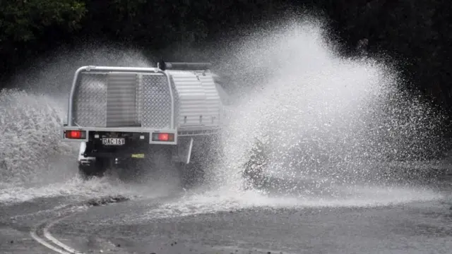 A car drives through floodwaters