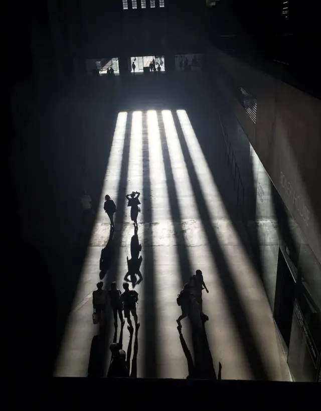Long shadows spread across the floor of the Tate Modern's Turbine Hall
