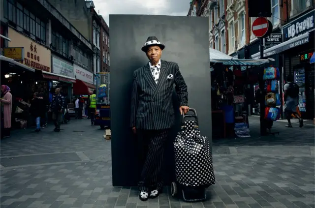 Portrait of a man in the street wearing a stripey suit