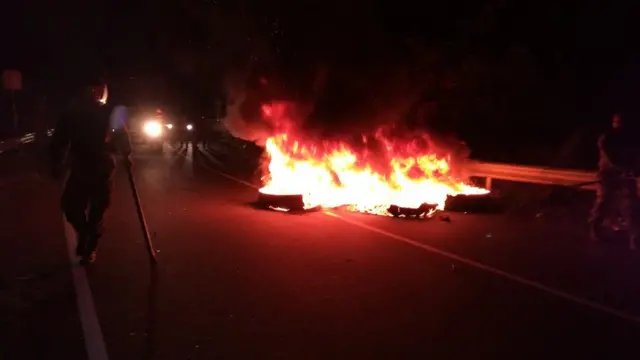 සැකකරුවන් රැගෙන යද්දී එක්තරා කණ්ඩායමක් මහා මාර්ගයේ ටයර් පුළුස්සමින් සිටි බව ප්‍රාදේශීය මාධ්‍යවේදීහු පවසති