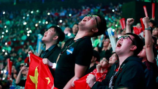 PSG.LGD gaming fans react during the Dota 2 grand final match between PSG.LGD and OG on Day 6 of The International 2018 at Rogers Arena on August 25, 2018 in Vancouver, Canada
