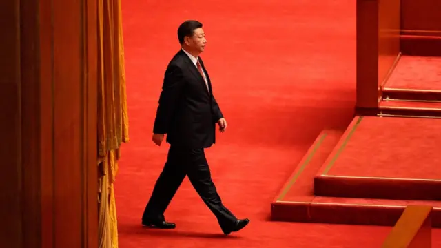This file photo taken on 1 August 2017 shows China"s President Xi Jinping arriving at a ceremony to commemorate the 90th anniversary of the founding of the People"s Liberation Army, at the Great Hall of the People in Beijing.
