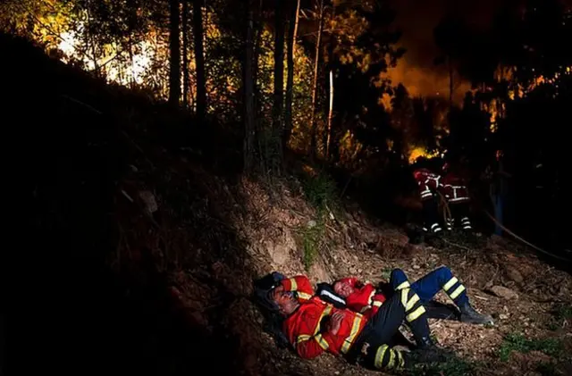 Firefighters rest during the wildfires of central Portugal in June 2017