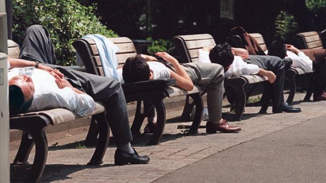 Japonenses tomando el sol en un banco