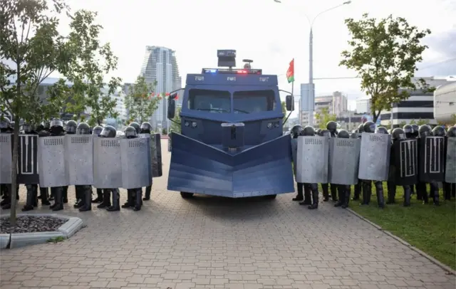 Belarusian riot police with snow-plough-like crowd control vehicle