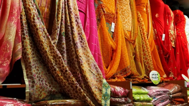 لباس‌های رنگین که به نظر می‌آید ساری‌های پاکستانی باشد در یک فروشگاه