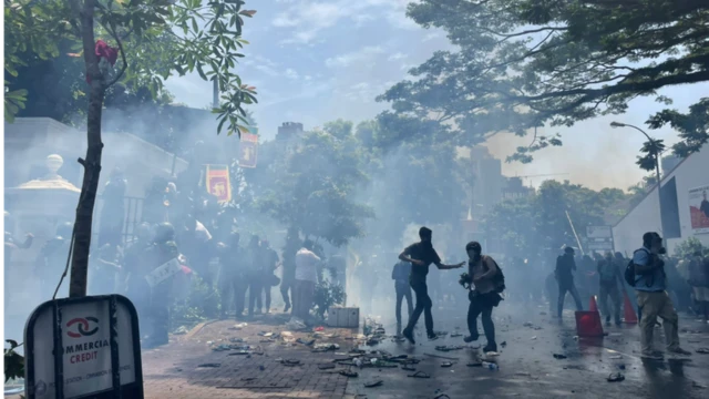Demonstrators face tear gas fired by police outside the PM's office, Colombo, 13 July 2022