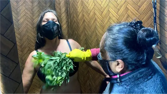 Emma Lagla utilise des herbes, dont l'ortie, pour effectuer un nettoyage spirituel sur l'écrivain.