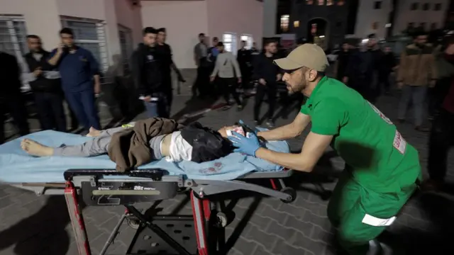 An injured child is brought to Shifa Hospital following Israeli air strikes in Gaza (9 May 2023)