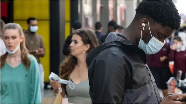 People on Oxford Street wearing face coverings