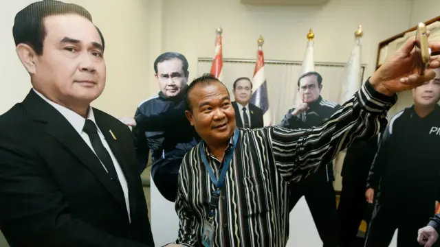 A Thai journalist takes a selfie with a life-size cardboard cutout replica of Thai Prime Minister Prayut Chan-o-cha which were prepared for the National Children"s Day event of the Government House, in Bangkok, Thailand, 09 January 2018.