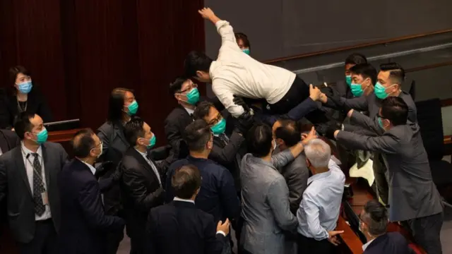 Pro-democracy lawmaker Ted Hui tried to jump onto the chairman's bench