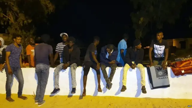 People gather outside the Tajoura Detention Centre after an air strike kills nearly 40 migrants east of Tripoli, 3 July