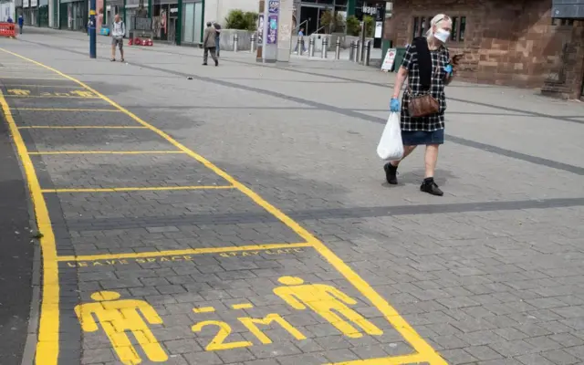 Social distancing markings have been painted on the pavement for people to try to stay 2 metres apart
