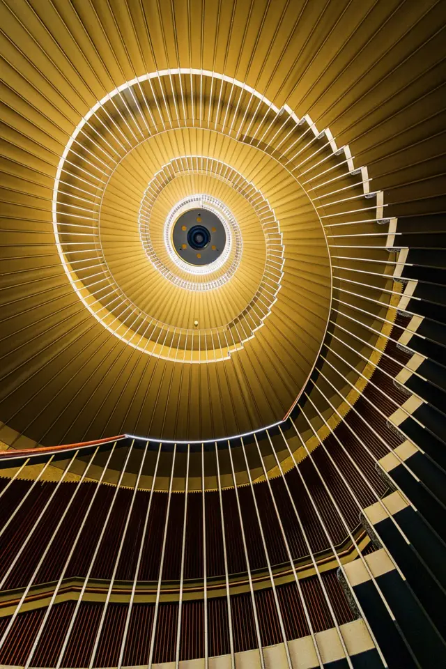 A view looking upward at a spiral staircase