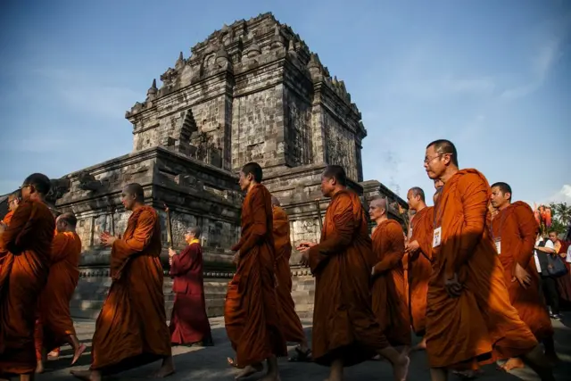 Buddhist monks walk around Mendut temple during the practice of Pradakshina ahead of Vesak Day in Magelang, Central Java, Indonesia, May 27, 2018