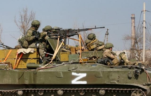 Service members of pro-Russian troops are seen atop of an armoured vehicle with a symbol "Z" painted on its side in the course of Ukraine-Russia conflict in the besieged southern port city of Mariupol, Ukraine March 24, 2022.
