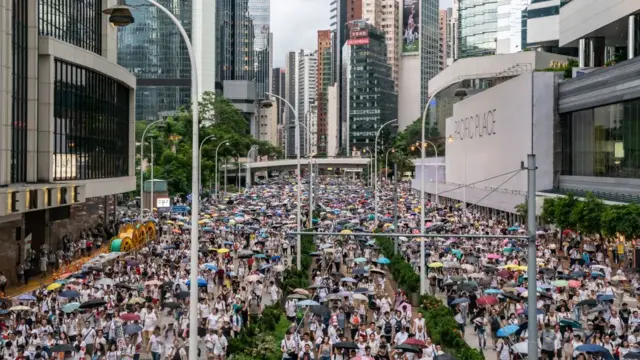 Protesters march on a street during a rally against a controversial extradition law proposal on June 9, 2019 in Hong Kong.