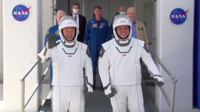 The crew members walked out just after 12:00 EDT (17:00 BST)