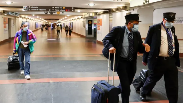 Amtrak personnel and others walk through Union Station on March 3, 2022 in Los Angeles, California.