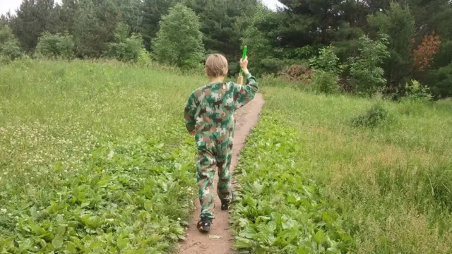 Matthew de espaldas caminando por un sendero en el campo