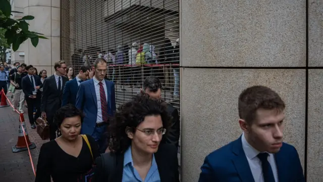 Foreign diplomats queue outside the West Kowloon Magistrates' Courts during a verdict for 47 pro-democracy activists in Hong Kong, China, 30 May 2024. A court in Hong Kong on 30 May convicted 14 defendants over 'conspiracy to subvert the state power' under the national security law, while two were acquitted, in trial of 47 prominent pro-democracy figures in Hong Kong arrested and charged in 2021.