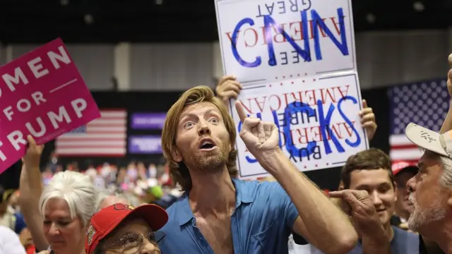 أنصار ترامب في إحدى المسيرات التي خاطبها رفعوا شعارات ضدها