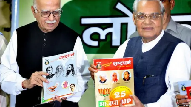 Former Indian Prime Minister Atal Behari Vajpayee (R) and Leader of Opposition L. K. Advani (L) release the Rashtriya Swayamsevak Sangh (RSS) magazine Rashtradharm and a book at Bharatiya Janta Party (BJP) headquarters, in New Delhi, 27 August 2006.