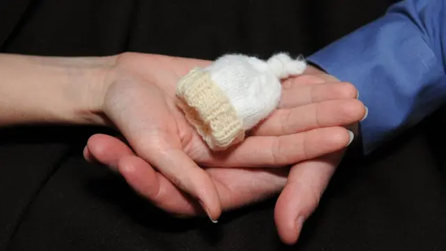 Manos con sombrerito de bebé