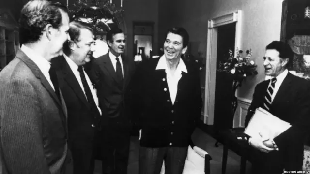 A cabinet meeting in the family quarters of the White House, Washington DC. From left to right: James Baker, Edwin Meese, Vice-President George HW Bush, Reagan and Caspar Weinberger, 1 Apr 1981