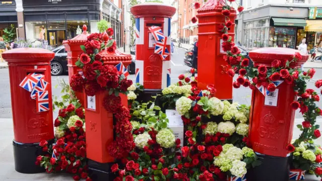 A flower display with post boxes is seen on Sloane Street during the free floral art show at Chelsea in Bloom.