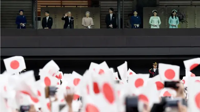 apan"s Emperor Akihito (3rd L) waves during his birthday public appearance with other members of the Imperial family,