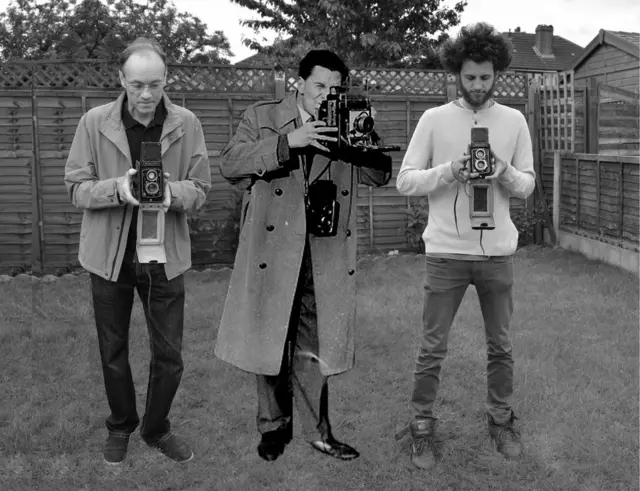 Tres generaciones de hombres con cámaras