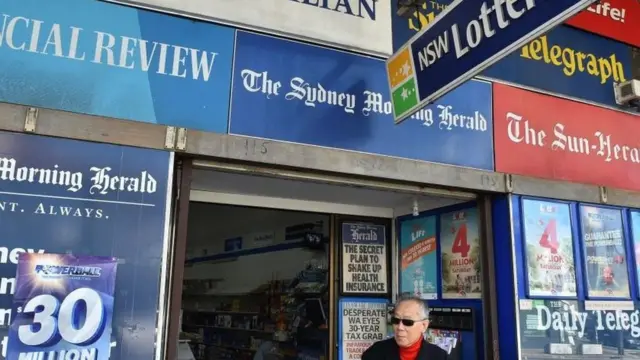 A man leaves a news agency shop in Sydney.