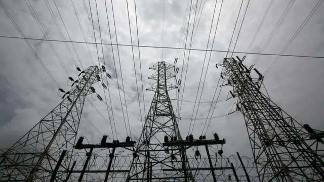 High-tension power lines are pictured outside a Tata Power sub station in the suburbs of Mumbai