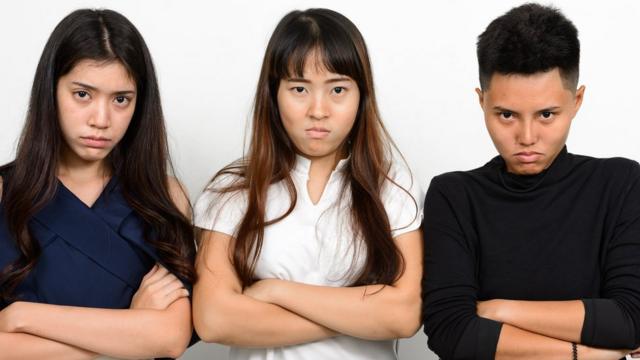 Stock picture of three Asian women looking unimpressed