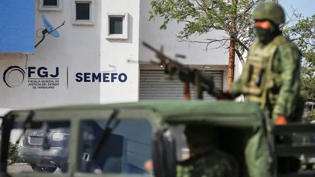Troops stand guard at the morgue where the Americans' bodies were taken