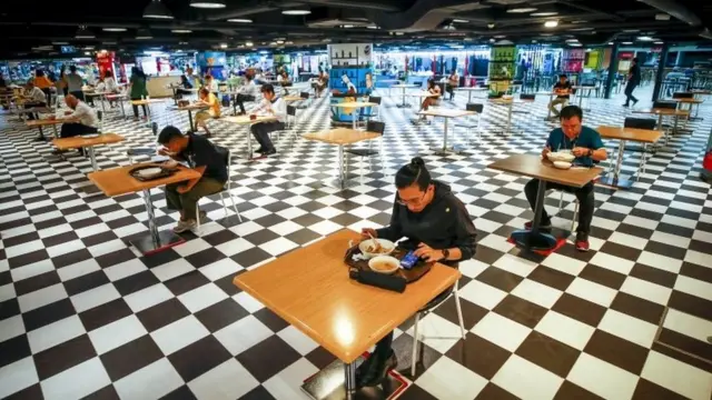 ลูกค้ากำลังรับประทานอาหารภายในศูนย์อาหารของอาคารสำนักงานในกรุงเทพฯ ภายหลังรัฐบาลประกาศผ่อนปรนข้อห้ามรับประทานอาหารภายในร้านอาหารได้ (17 พ.ค.)