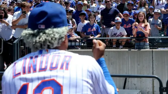 Jun 20, 2022; New York City, New York, USA; New York Mets shortstop Francisco Lindor (12) plays a game of rock, paper, scissors with fan Bea Dauber, 10, of Englewood, NJ, before a game against the Miami Marlins at Citi Field. Mandatory Credit: Brad Penner-USA TODAY Sports