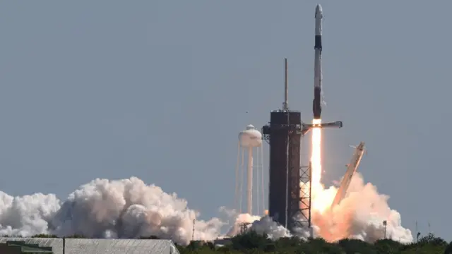 A SpaceX Falcon 9 rocket with a Crew Dragon spacecraft and four private astronauts launches