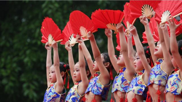 Kindergarten students dance during a Chinese traditional culture performance at Wusheng County on May 10, 2017 in Guang'an, Sichuan Province of China. Items including martial arts, sing and dance, reading poetry, art of tea, writing Chinese calligraphy are performed by about 1,000 kindergarten students to promote Chinese traditional culture.