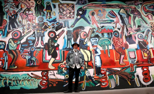 Moroccan artist Yassine Balbzioui poses next to his work Fantasy at the Reina Sofia Museum in Madrid, Spain - Tuesday 30 March 2021