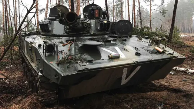 A Russian armoured vehicle in woodland with a "v" painted on it