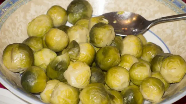 Вареная брюссельская капуста в миске с ложкой