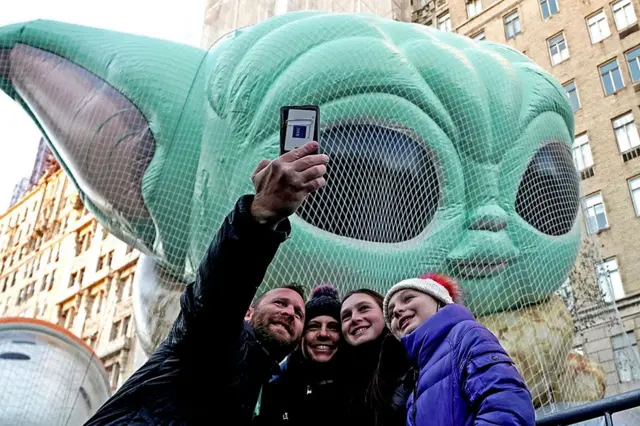 న్యూయార్క్‌లో గ్రోగు బెలూన్ వద్ద సెల్ఫీలు దిగుతున్న ప్రజలు. దీన్ని బేబీ యోధా అని కూడా పిలుస్తారు.