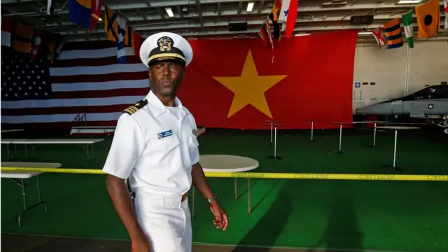 A sailor guard walks aboard the U.S. Navy aircraft carrier, USS Carl Vinson, after it docked at a port in Danang, Vietnam March 5, 2018.